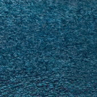 Teal velvet fabric texture with irregular ripples, displaying a plush surface and subtle sheen; “egoitaliano” brand detail visible.